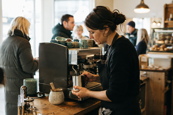 Barista working at a busy Irish café counter