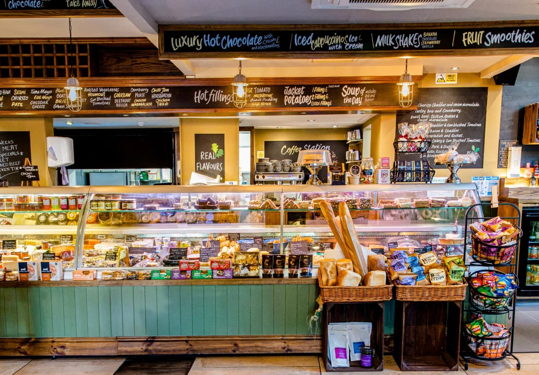 Deli counter with hot food display and menu boards