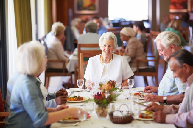 Catering staff preparing meals in a nursing home kitchen